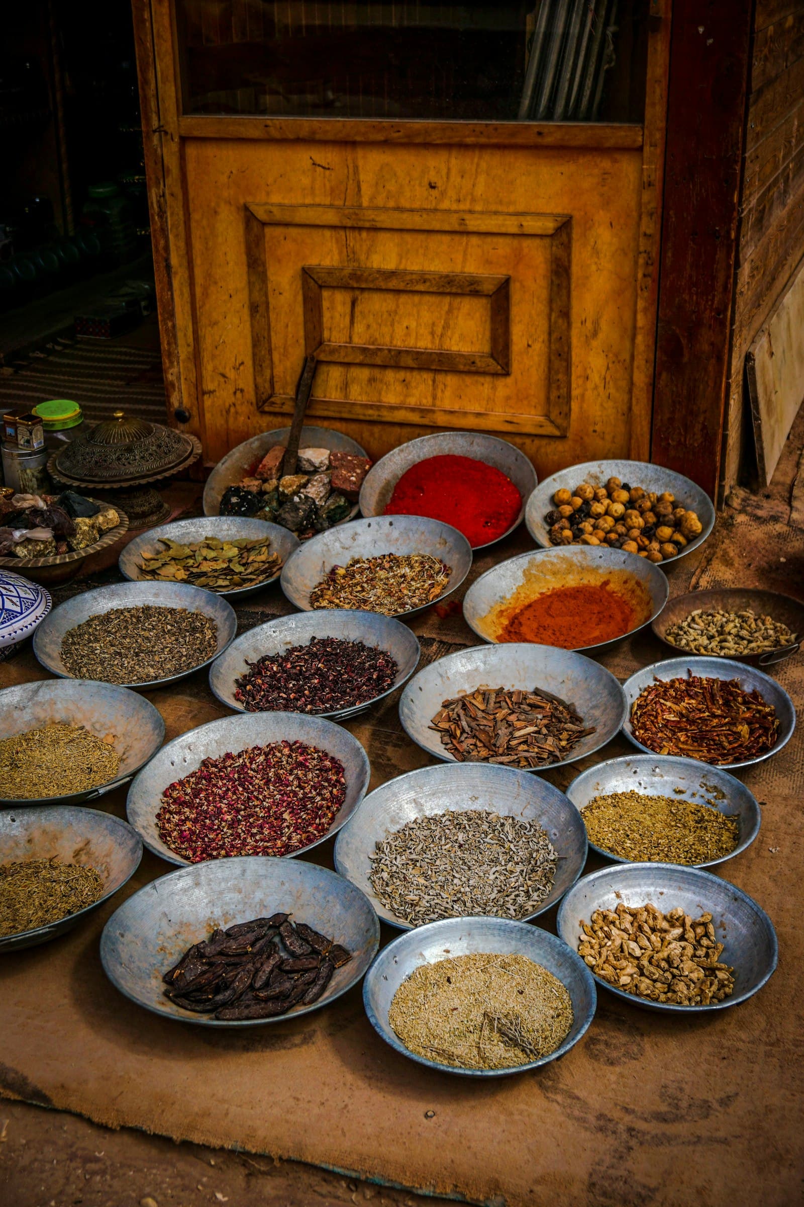 Bowls of whole spices set out in a traditional kitchen